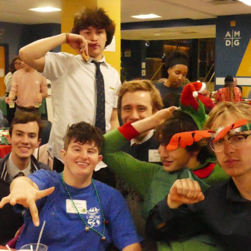 Jessie (in blue) goofs around with some of the students at the holiday party in 2019